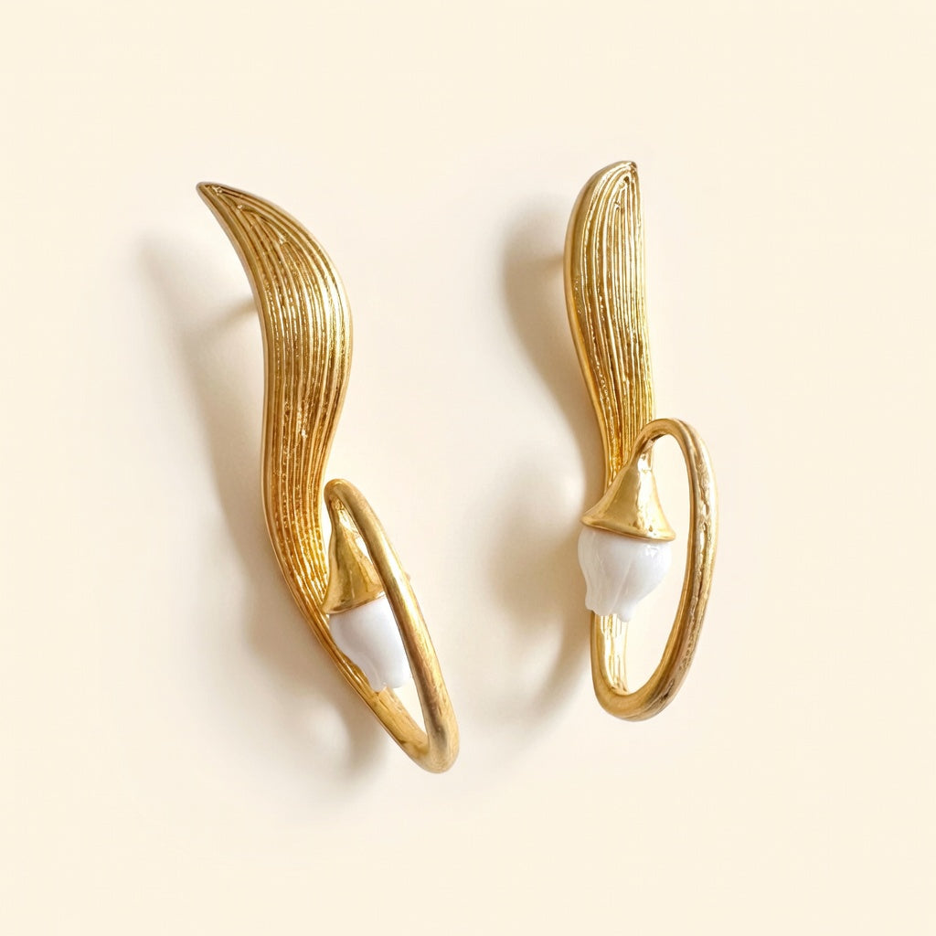 Gold clip-on earrings with white lily of the valley petals, oval halo frame