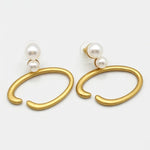 Vintage O-ring pearl earrings with gold-tone hoops and white pearl drops