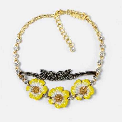 Gold-tone pendant necklace with yellow enamel flower charms and clear crystal bead accents