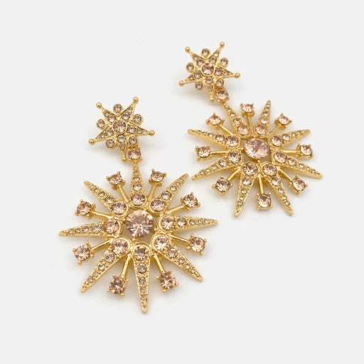 Gold-tone crystal starburst earrings with pink center stones