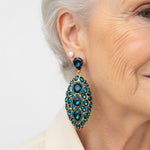 Turquoise and blue teardrop clip-on earrings with faceted crystal settings on ear