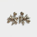 Silver-toned metal bow stud earrings with round stud tops and layered bow charms
