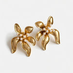 Floral enamel earrings with gold petals, pearl beads, and gold-tone setting