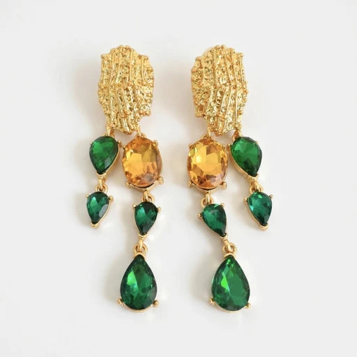 Asymmetrical crystal tassel earrings with green and amber teardrop stones on gold-tone frames