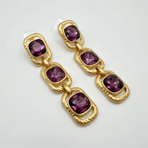 Gold-tone clip-on drop earrings with purple square crystals