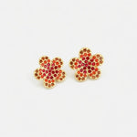 Floral stud earrings with gold setting and red gem clusters