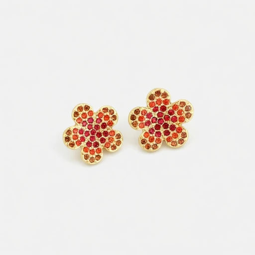 Floral stud earrings with gold setting and red gem clusters