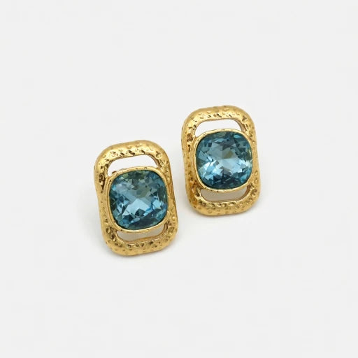 Square crystal stud earrings with gold-tone frames and light blue stones