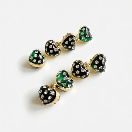 Gold-tone heart drop earrings with green enamel and clear rhinestones, dangling hearts