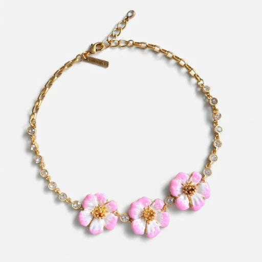 Gold-tone pendant necklace with pink enamel flower charms and crystal bead accents