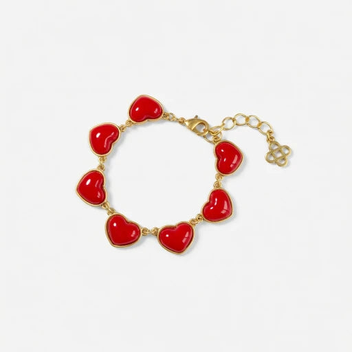 Gold heart charm bracelet with red enameled heart links and chain extender