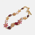 Floral zircon necklace with gold-tone chain and pink and ruby-colored gem flower links