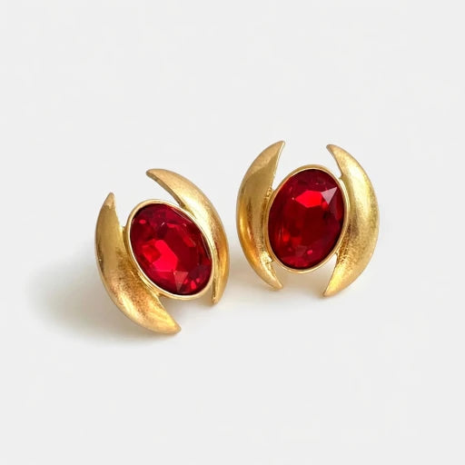 Oval crystal earrings with gold-tone curved settings and ruby-red oval stones