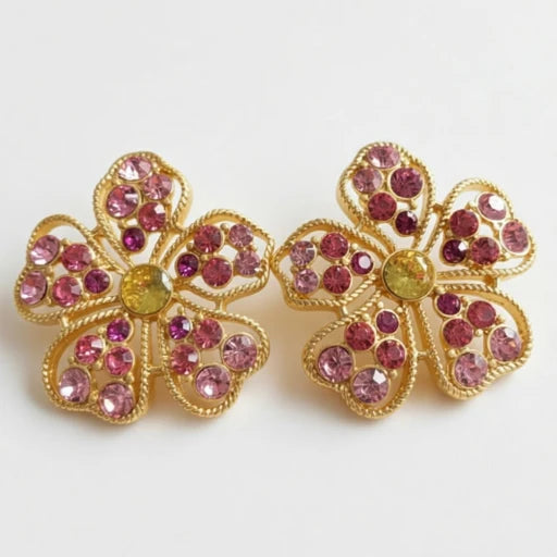 Floral stud earrings with pink pavé petals and round green center, gold-tone setting.