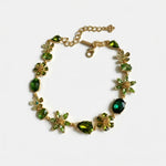 Floral zircon necklace with gold-tone chain and green gemstone flower links