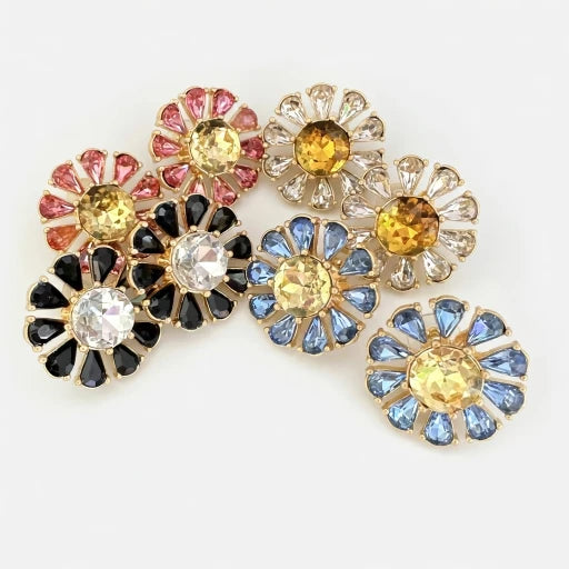 Assorted flower stud earrings with yellow centers in pink, black, white, and blue stones