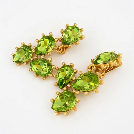 Sparkling glass diamond ear clips with green oval stones and gold-tone settings