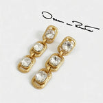 Gold-tone clip-on drop earrings with clear square crystals