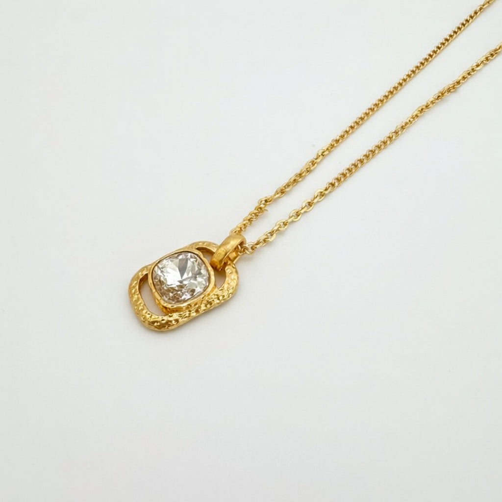 Gold square pendant necklace with hammered texture and clear faceted gemstone
