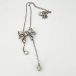 Vintage bow crystal tassel necklace with silver-tone chain and dangling charm drops