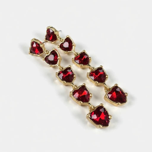 Red heart-shaped crystal drop earrings with gold-tone chain links.