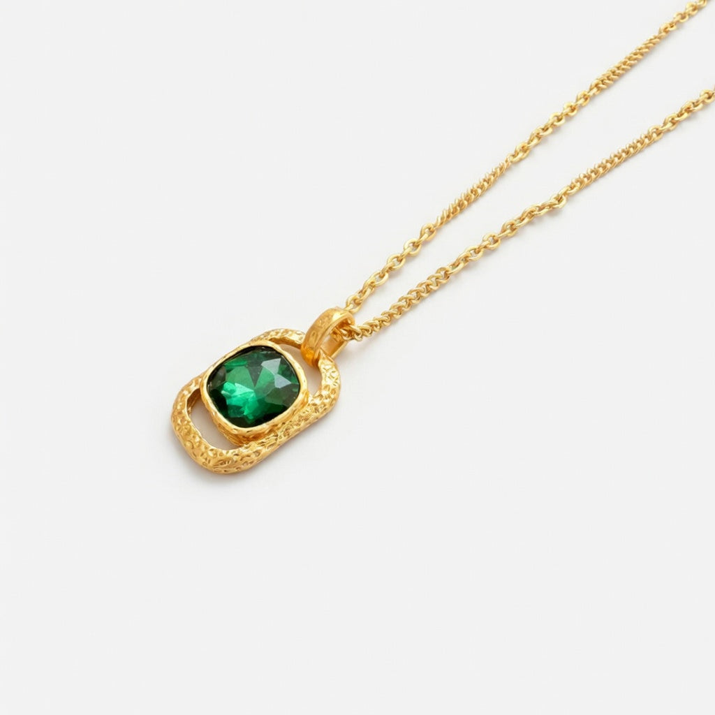Gold square pendant necklace with hammered texture and green faceted gemstone